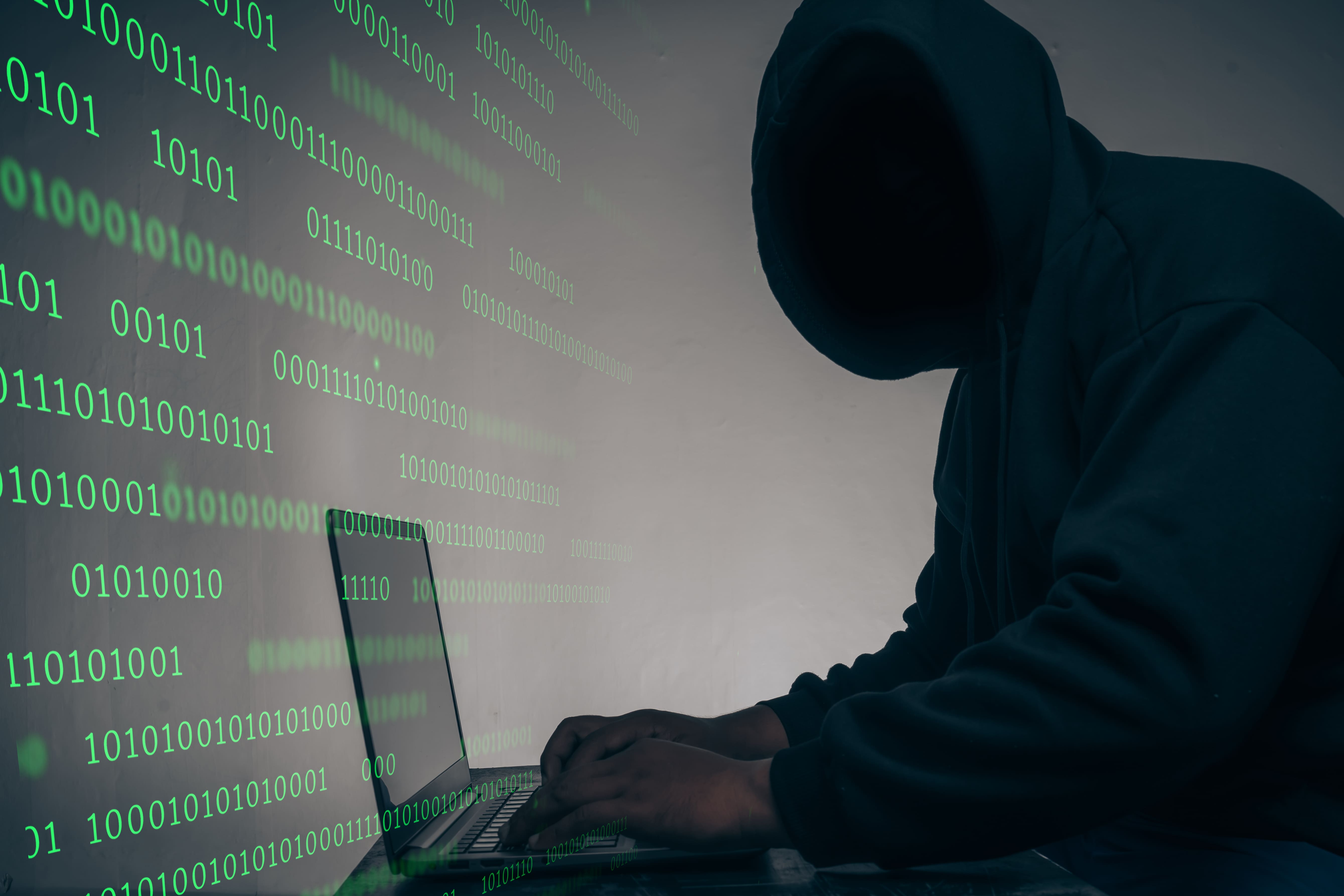 hacker-was-wearing-black-hoodie-stealing-huge-financial-data-computers-with-binary-code