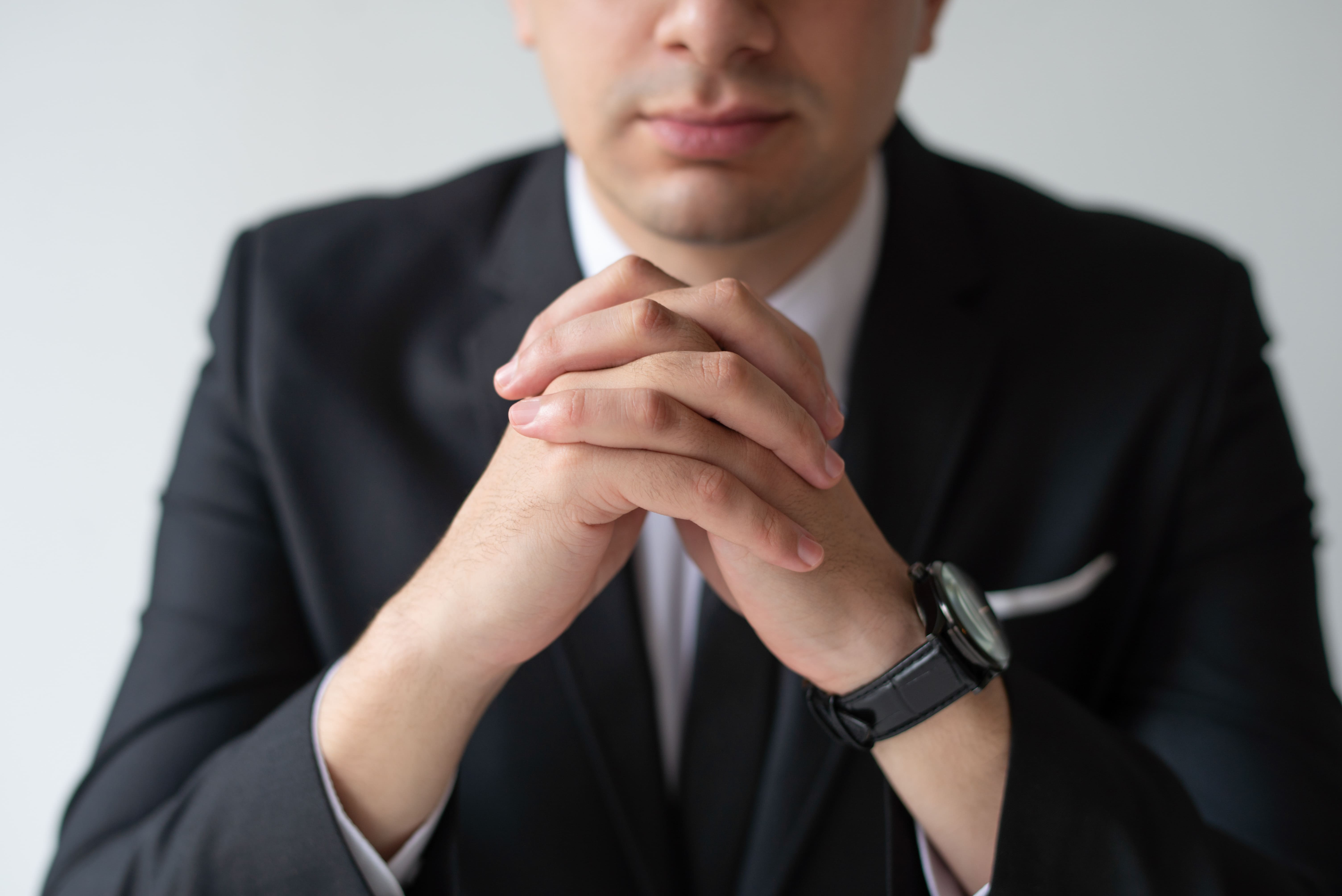 closeup-business-man-with-clasped-hands