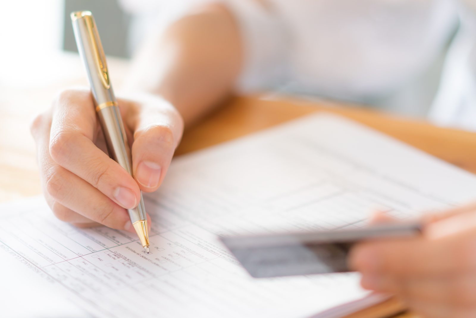 hand-with-pen-credit-card-application-form
